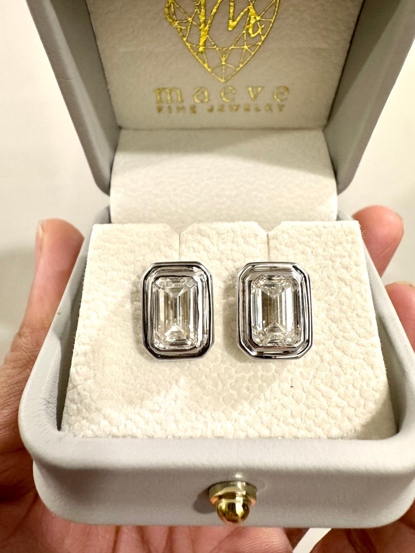 Maeve Atelier: 3 + 3 carats Emerald Cut Bezel Set Studs